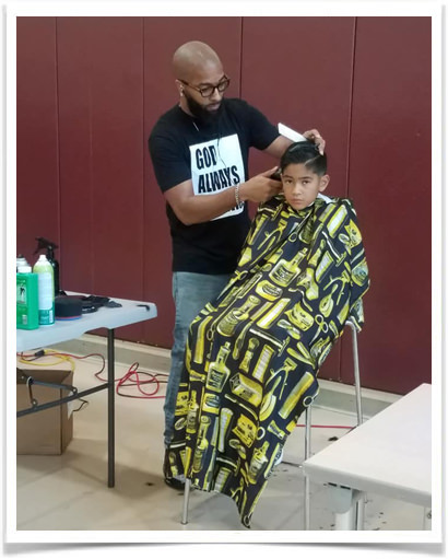 Man cutting child's hair